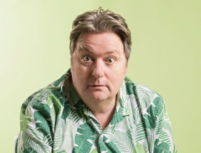 Photo of Dave O'Neil in a green shirt with a green background.