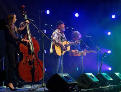 A quartet of musicians live on stage.