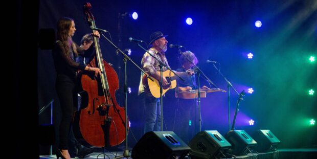 A quartet of musicians live on stage.