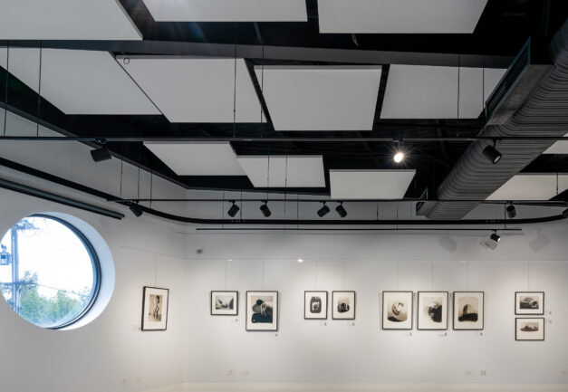 Interior photo of a modern gallery with a large circle window.